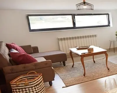 a living room with a couch and a coffee table at Ático con maravillosas vistas in Viveiro