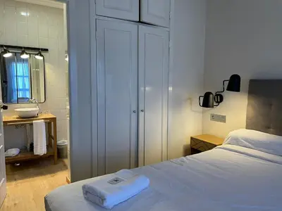 a bedroom with a bed and a bathroom with a mirror at Hotel San Marcus in Porta