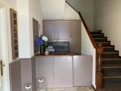 a kitchen with a staircase with a vase of flowers at Hotel San Marcus in Porta