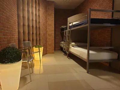 a room with bunk beds in a brick wall at albergue SANTO SANTIAGO in Santiago de Compostela