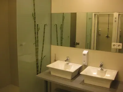 a bathroom with two sinks and a mirror at albergue SANTO SANTIAGO in Santiago de Compostela