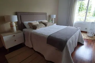 a bedroom with a bed with two night stands and two lamps at Centro pueblo Santa Cruz - Oleiros - A Coruña in Santa Cruz de Oleiros