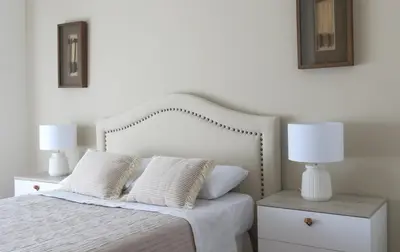 a white lamp on a night stand next to a bed at Centro pueblo Santa Cruz - Oleiros - A Coruña in Santa Cruz de Oleiros
