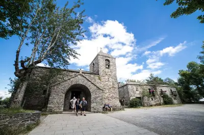 a group of people standing around a bike at Casa O Cebreiro in O Cebreiro