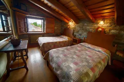a bathroom with a sink and a toilet and a mirror at Casa O Cebreiro in O Cebreiro