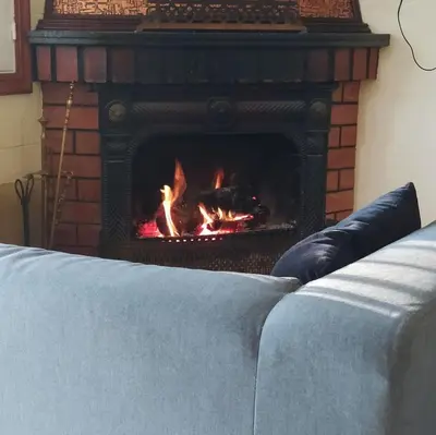 a fireplace in a living room with a fire in it at Finca Segade in A Estrada