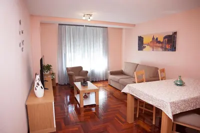 a living room with a couch and a table at Laros Pios Alojamiento 2 in Villalba