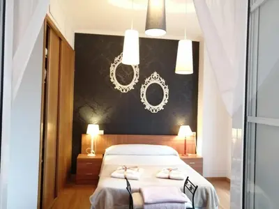 a bedroom with a bed with a black wall at BERAMAR APARTMENT in Viveiro