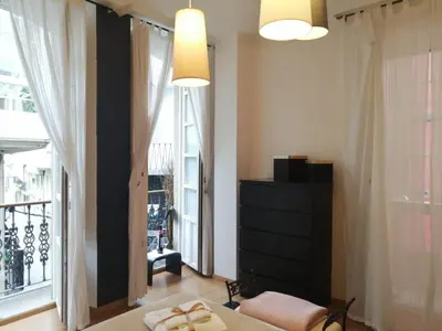 a bedroom with a bed and a large window at BERAMAR APARTMENT in Viveiro