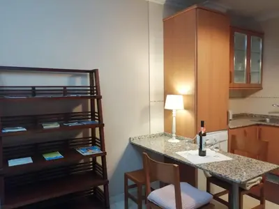 a small kitchen with a table and chairs in a room at BERAMAR APARTMENT in Viveiro