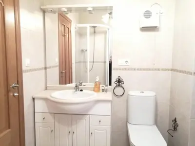 a white bathroom with a sink and a toilet at BERAMAR APARTMENT in Viveiro