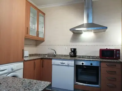 a kitchen with a sink and a stove top oven at BERAMAR APARTMENT in Viveiro