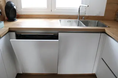 a white kitchen with a sink and a counter at Tu Rincón en Compostela in Santiago de Compostela