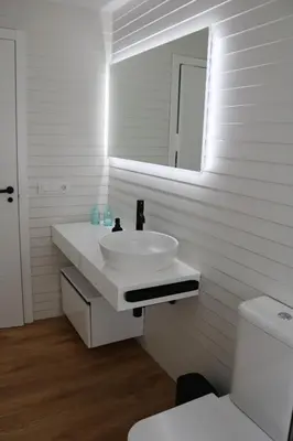 a white bathroom with a sink and a mirror at Tu Rincón en Compostela in Santiago de Compostela