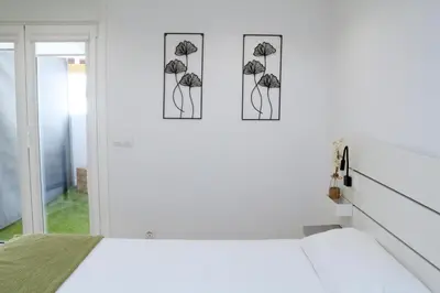 a bedroom with three pictures hanging on the wall at Tu Rincón en Compostela in Santiago de Compostela