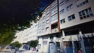 a tall white building on a city street at Tu Rincón en Compostela in Santiago de Compostela