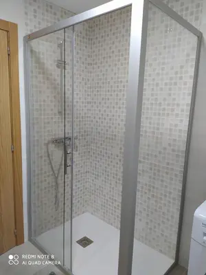a shower with a glass door in a bathroom at Piso de alquiler en Tapia de Casariego in Tapia de Casariego
