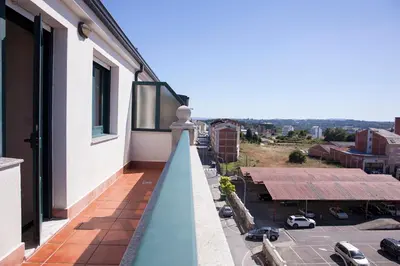 a balcony with a view of a parking lot at Laros Pios Alojamiento 1 in Villalba