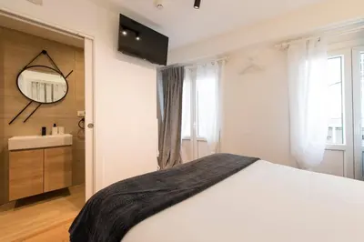 a bedroom with a bed and a sink and a mirror at Hotel A Falúa in Puentedeume