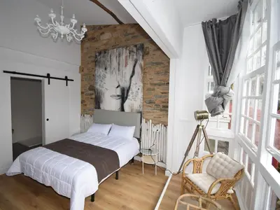 a bedroom with a bed and a brick wall at Hotel A Falúa in Puentedeume