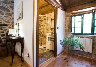 a room with a hallway with a table and a window at A Casa dos Avós - Vilariño - A Coruña in Vilariño