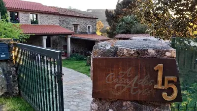 a sign on a rock in front of a house at A Casa dos Avós - Vilariño - A Coruña in Vilariño
