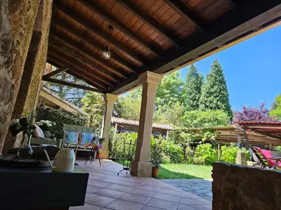 an outdoor patio with a wooden pergola at A Casa dos Avós - Vilariño - A Coruña in Vilariño