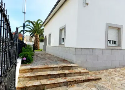 a white house with stairs and a fence at Casa Sueño in Foz