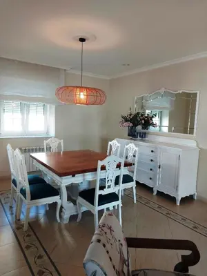 a dining room with a table and chairs and a mirror at Casa Sueño in Foz