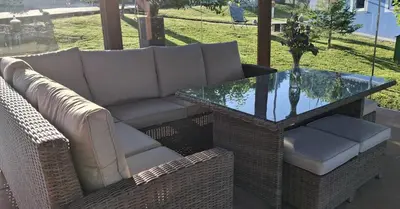 a wicker couch and a glass table on a patio at Casa rural La casilla de Ois-Betanzos-A Coruña in Coirós