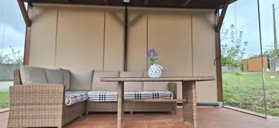 a table and a couch on a patio at Casa rural La casilla de Ois-Betanzos-A Coruña in Coirós