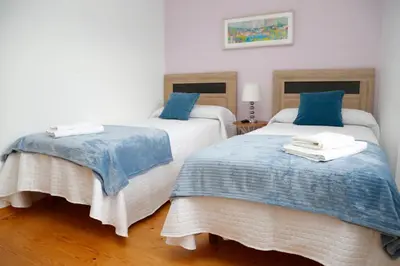 two beds sitting next to each other in a room at Casa Muiño dos Frades in Lourenzá