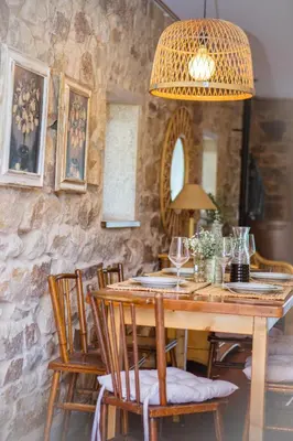 a dining room with a wooden table and chairs at Miña Nai, Casa Rural in Lalín