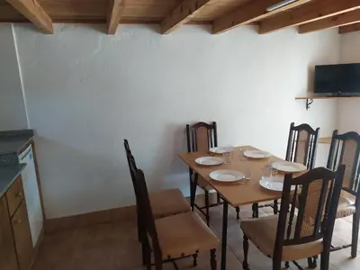 a dining room with a wooden table and chairs at CASA 
