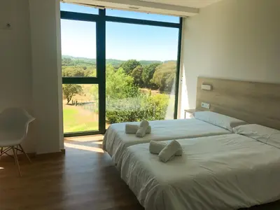 a bedroom with a large bed with a large window at Vía Sacra in Porta
