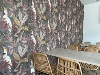 a dining room with a table and chairs with a floral wallpaper at Vía Sacra in Porta