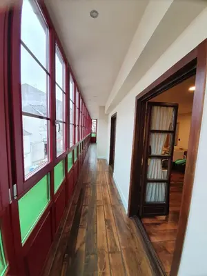 an empty hallway of a building with windows at Albergue Casa Cuartel in Fonsagrada
