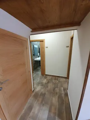 a room with a white door and a wooden floor at Albergue Casa Cuartel in Fonsagrada