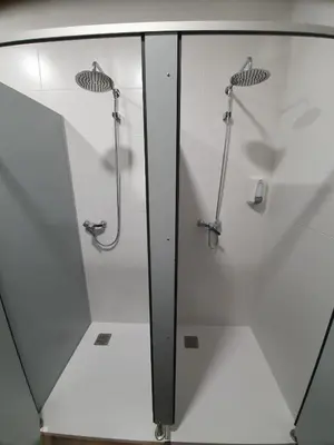 a glass shower stall in a bathroom with a shower at Albergue Casa Cuartel in Fonsagrada
