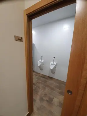 a bathroom with two urinals on the wall at Albergue Casa Cuartel in Fonsagrada