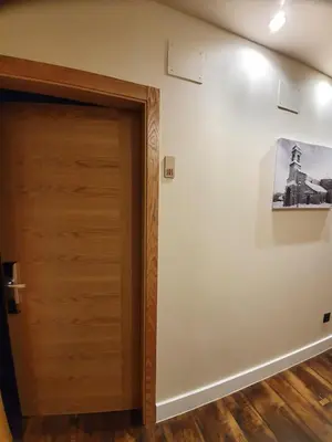 a room with a door and a picture on the wall at Albergue Casa Cuartel in Fonsagrada
