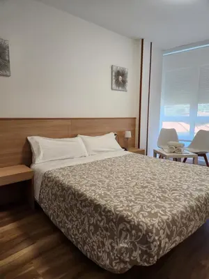 a bedroom with a large bed and a window at Hospedaje Norte in Puentedeume