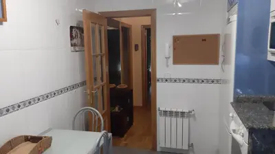a room with a hallway with a door and a room with a table at Piso Tranquilo Ponferrada in Ponferrada