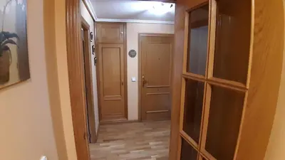 an empty hallway with wooden cabinets and a door at Piso Tranquilo Ponferrada in Ponferrada