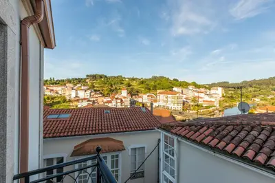 a view of a city from the balcony of a building at MIRADOR DE LA MURALLA in Betanzos