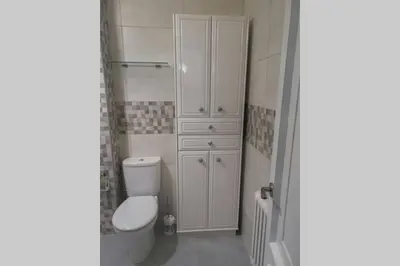 a white bathroom with a toilet and a shower at Apartamento Lalín Centro ll in Lalín