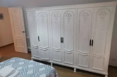 a white wardrobe in a bedroom with a bed at Apartamento Lalín Centro ll in Lalín