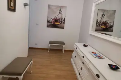 a room with a dresser and a bench in it at Apartamento Lalín Centro ll in Lalín