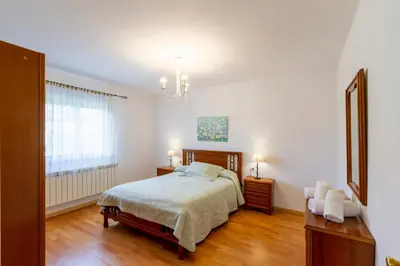 a bedroom with a bed and a chandelier at CASA NIDES in Doade
