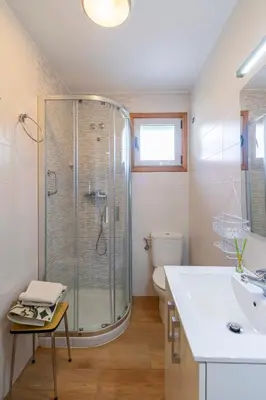 a bathroom with a shower and a sink and a toilet at CASA NIDES in Doade